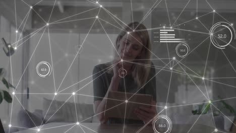 Animation-of-network-of-connections-with-data-over-caucasian-businesswoman-with-tablet