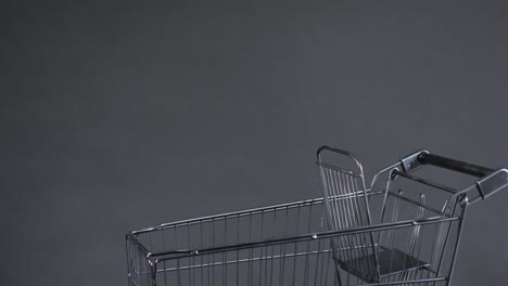 Video-of-shopping-trolley-with-copy-space-over-grey-background