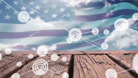 Animation-of-connected-wifi-and-phone-icons-over-flag-of-america,-clouds-and-wooden-table