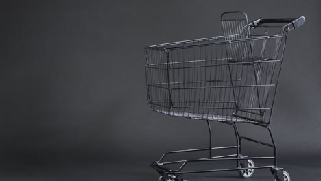 Video-of-shopping-trolley-with-copy-space-over-grey-background