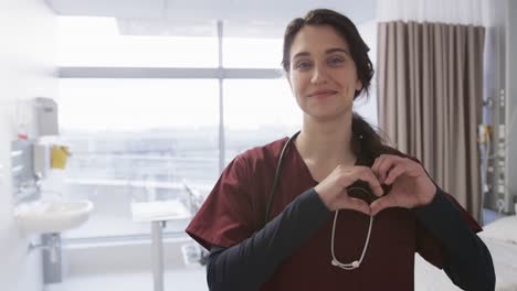Portrait-of-happy-caucasian-female-doctor-in-hospital-room,-slow-motion