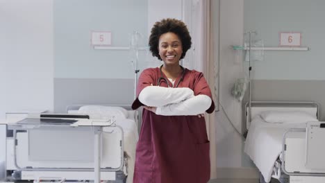 Portrait-of-happy-african-american-female-doctor-in-hospital-room,-slow-motion