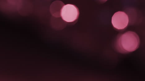 Video-of-flickering-white-and-pink-bokeh-spots-of-light-with-copy-space
