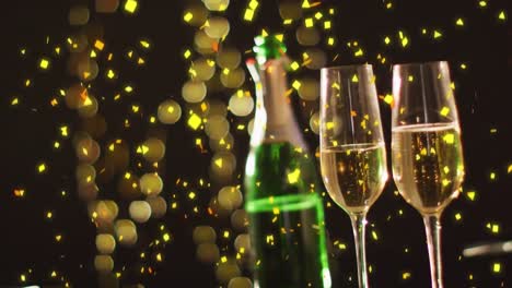 Animation-of-confetti-falling-on-champagne-glasses-and-bottle-over-black-background
