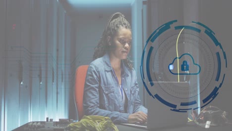 Animation-of-padlock-in-circle-over-african-american-female-engineer-using-laptop-at-data-centre
