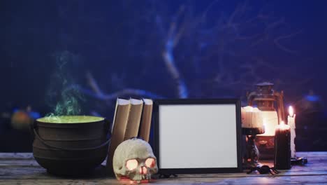 Video-of-frame-wth-copy-space,-books,-skull-and-candles-on-blue-background