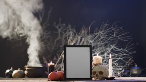 Video-of-frame-wth-copy-space,-spider-web,-skull-and-candles-on-black-background
