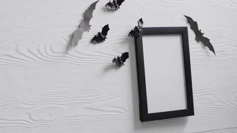 Video-of-black-frame-and-bats-with-copy-space-on-white-background