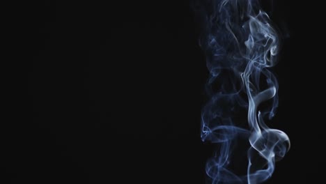 Video-of-white-clouds-of-smoke-moving-with-copy-space-on-black-background