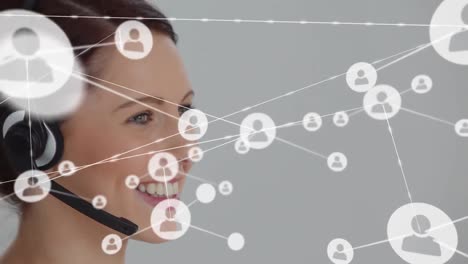 Animation-of-network-of-profile-icons-against-caucasian-woman-talking-on-phone-headset-at-office