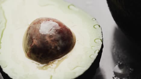 Micro-video-of-close-up-of-avocados-with-copy-space-on-grey-background