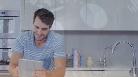 Animation-of-statistical-data-processing-over-caucasian-man-smiling-while-using-tablet-at-home