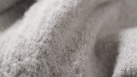 Micro-video-of-close-up-of-grey-wooly-fabric-with-copy-space