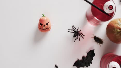 Video-of-halloween-drink-and-decorations-with-copy-space-on-white-background