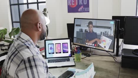 African-american-businessman-on-video-call-with-african-american-female-colleague-on-screen
