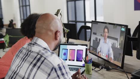 African-american-business-people-on-video-call-with-caucasian-male-colleague-on-screen