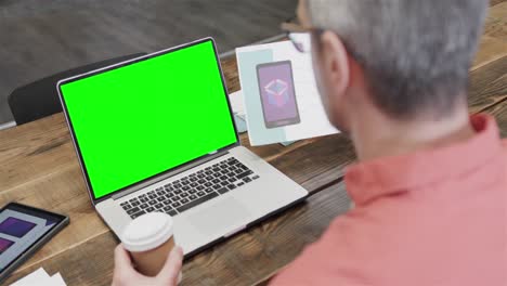 Caucasian-businessman-on-laptop-video-call-with-green-screen