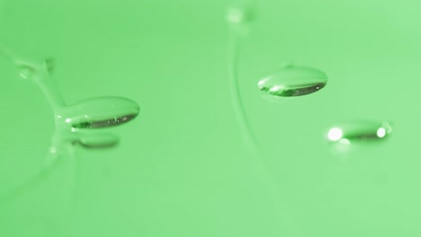 Micro-video-close-up-of-water-drops-with-copy-space-on-green-background