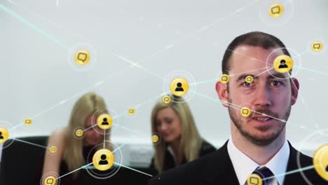Animation-of-network-of-digital-icons-against-portrait-of-a-caucasian-businessman-at-office