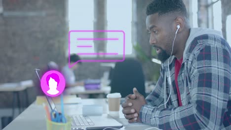 Animation-Von-Mediensymbolen-über-Einem-Afroamerikanischen-Geschäftsmann,-Der-Im-Büro-Einen-Laptop-Benutzt