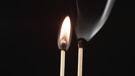 Video-of-close-up-of-matches-with-yellow-fire-flame-and-copy-space-on-black-background