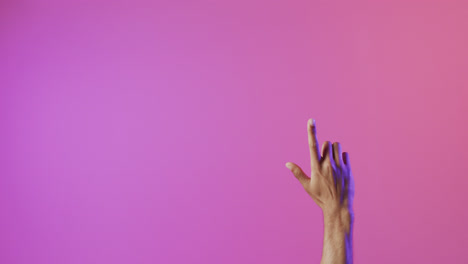 Video-of-biracial-man-pointing-finger-using-holographic-display,-with-pink-copy-space