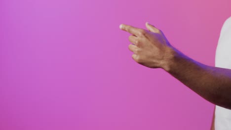 Video-of-biracial-man-pointing-finger-using-holographic-display,-with-pink-copy-space
