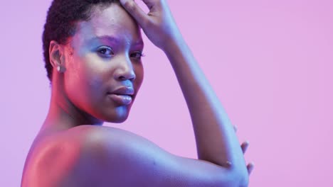 African-american-woman-with-short-dark-hair-in-blue-and-pink-light,-slow-motion