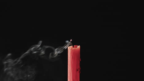 Video-of-red-candle-with-white-flame-and-copy-space-on-black-background