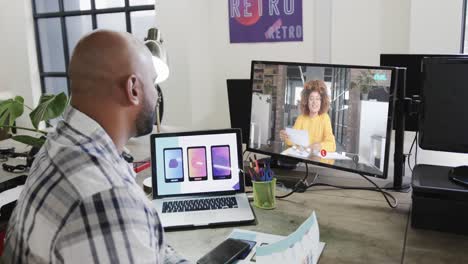 African-american-businessman-on-video-call-with-african-american-female-colleague-on-screen
