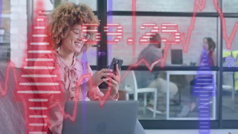 Blue-and-red-graphs-and-arrows-over-happy-biracial-businesswomen-using-smartphone-in-office