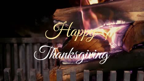Animation-of-happy-thanksgiving-text-banner-against-close-up-view-of-burning-autumn-leaves