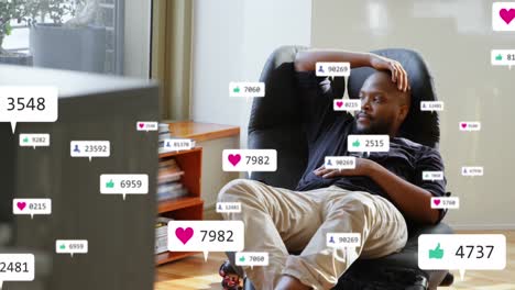 Animation-of-social-media-icons-over-african-american-man-looking-out-of-the-window-at-home