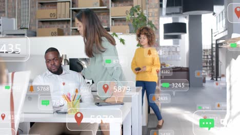 Social-media-notifications-over-diverse-colleagues-in-discussion-at-laptop-in-casual-office
