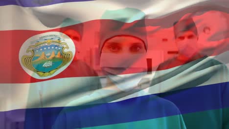 Animation-of-waving-costa-rica-flag-against-portrait-of-team-of-diverse-surgeons-at-hospital