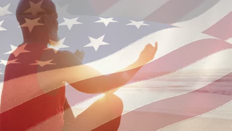 Animation-of-flag-of-usa-over-senior-african-american-man-practicing-yoga-on-beach