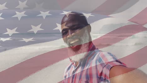 Animation-of-flag-of-usa-over-happy-senior-african-american-man-on-beach