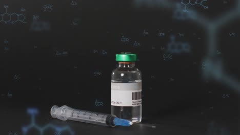 Syringe-and-vaccine-vial-over-element-structure-diagrams-on-black-background
