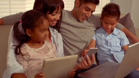 Smiling-Hispanic-family-on-different-devices