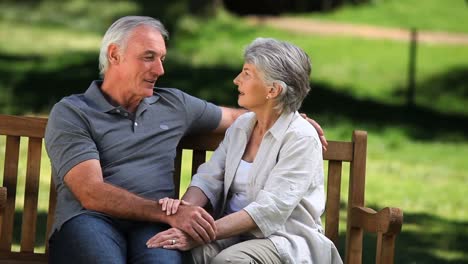 Adorable-old-couple-relaxing-on-a-bench