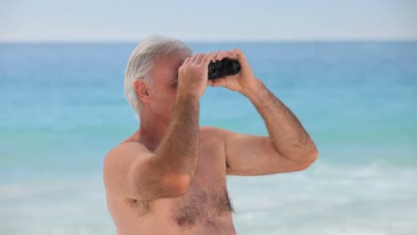 Elderly-man-looking-through-binoculars