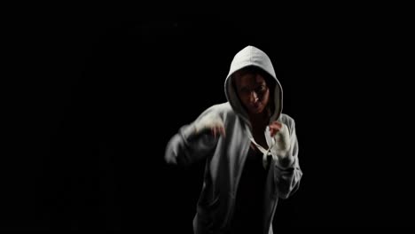 Muscular-woman-with-grey-hood-boxing