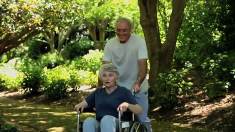 Man-strolling-with-his-wife-in-a-wheelchair