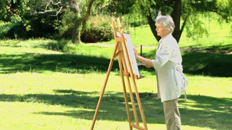 Old-woman-painting-a-canvas