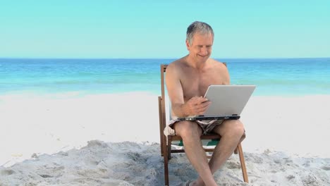 Elderly-man-working-on-his-laptop