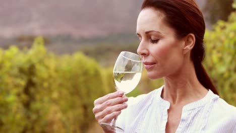 Female-winegrower-swirling-a-white-wine-glass