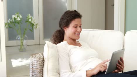 Schwangere-Frau-Entspannt-Sich-Mit-Tablet-Auf-Der-Couch
