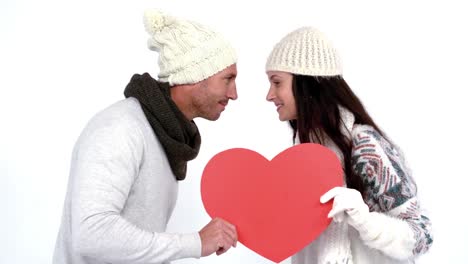 Winter-couple-holding-heart-card