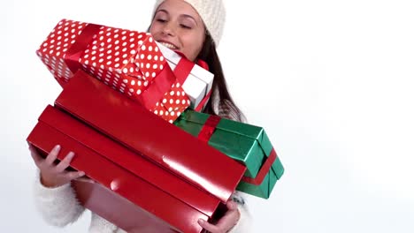 Festive-woman-carrying-pile-of-gifts