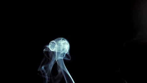 Smoke-rising-on-black-background